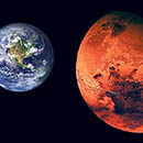 Two planets - Earth and Mars. Mars is closer as if we are orbiting Mars and looking beyond it to distant Earth.